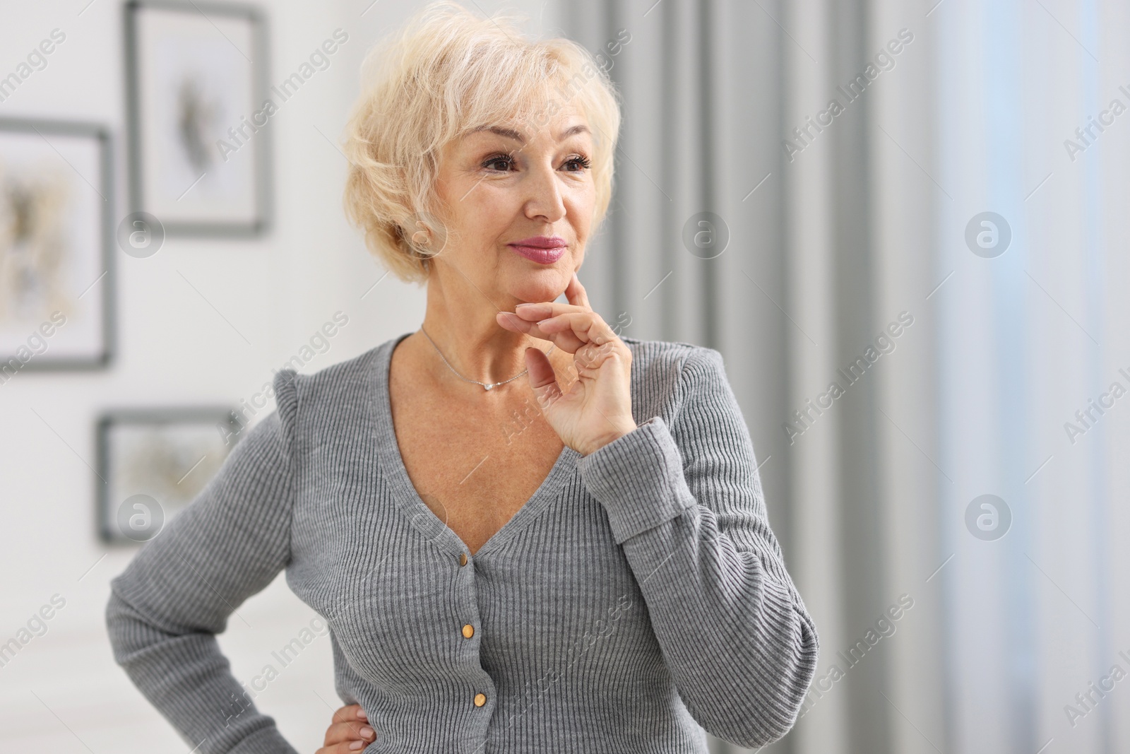 Photo of Portrait of beautiful grandmother at home. Space for text