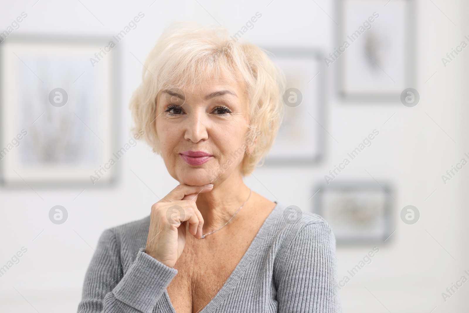 Photo of Portrait of grandmother with beautiful makeup at home. Space for text