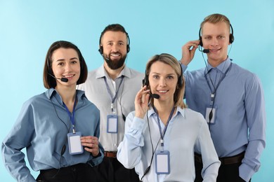 Photo of Technical support call center. Team of friendly operators on light blue background