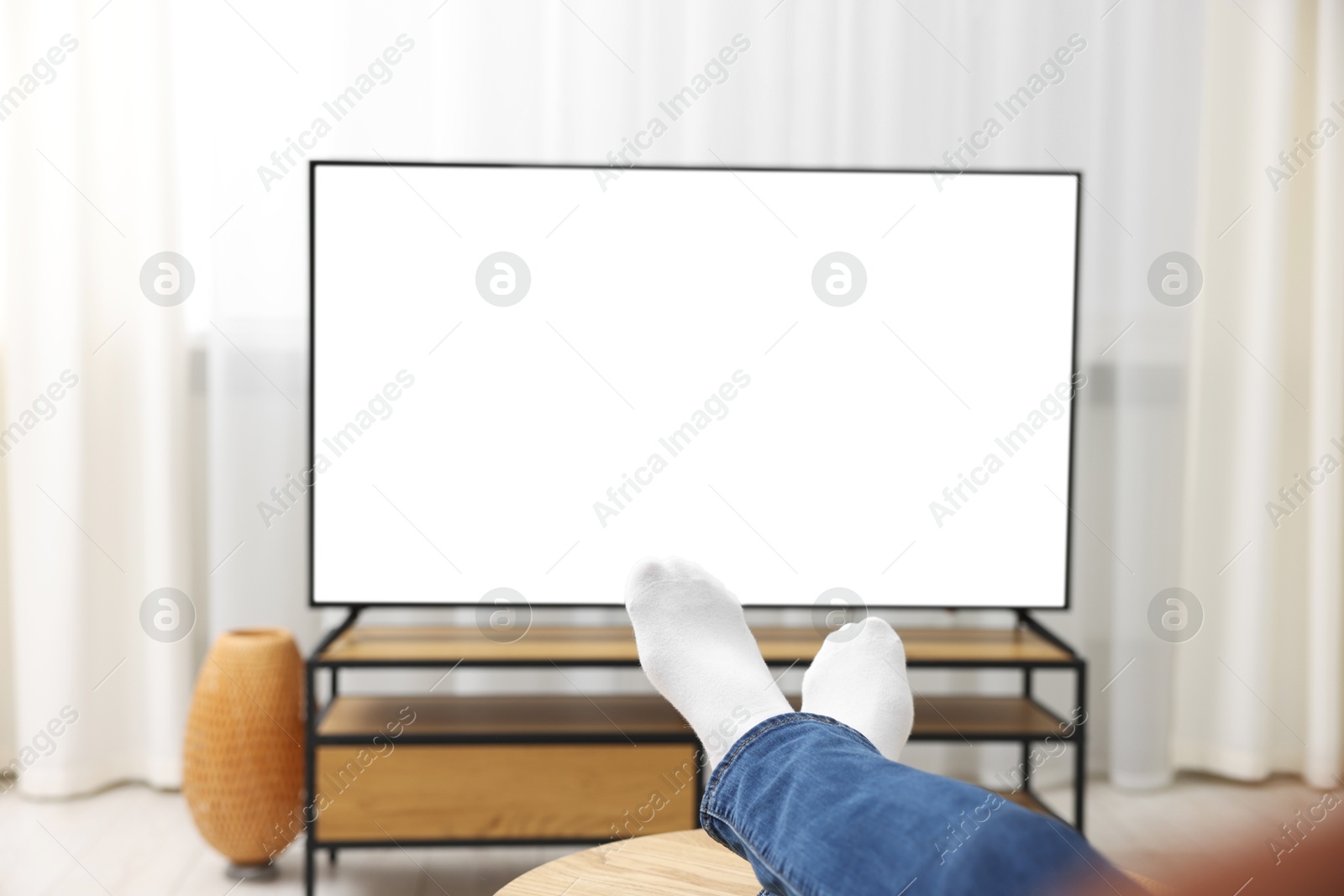 Photo of Woman watching tv at home, closeup view