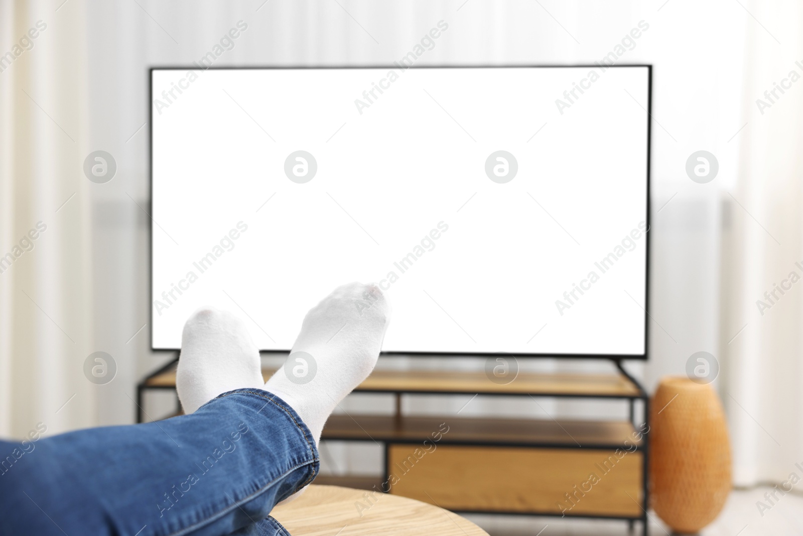 Photo of Woman watching tv at home, closeup view