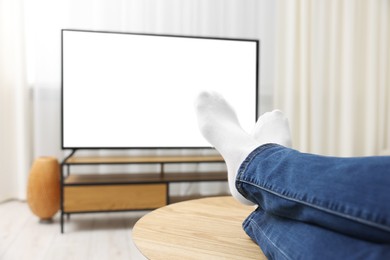 Photo of Woman watching tv at home, closeup view