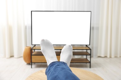 Photo of Woman watching tv at home, closeup view