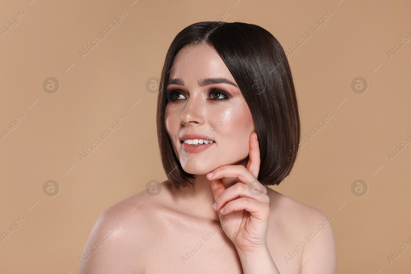 Photo of Portrait of beautiful young happy woman with gorgeous straight hair on beige background