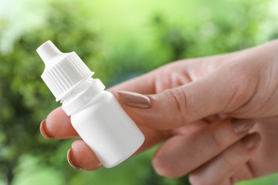 Photo of Allergy treatment. Woman with medical drops on blurred background, closeup