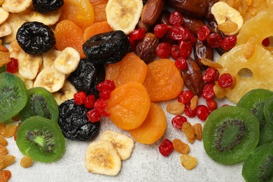 Photo of Mix of different dried fruits on grey table, top view