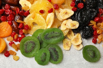 Photo of Mix of different dried fruits on grey table, top view