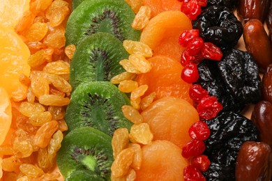 Photo of Different dried fruits as background, top view