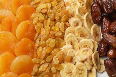 Photo of Different dried fruits as background, top view