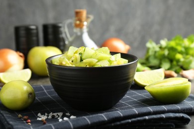 Photo of Delicious salsa (Pico de gallo) in bowl and products on table, closeup