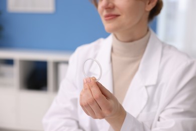 Photo of Contraception. Gynecologist showing vaginal ring in clinic, closeup