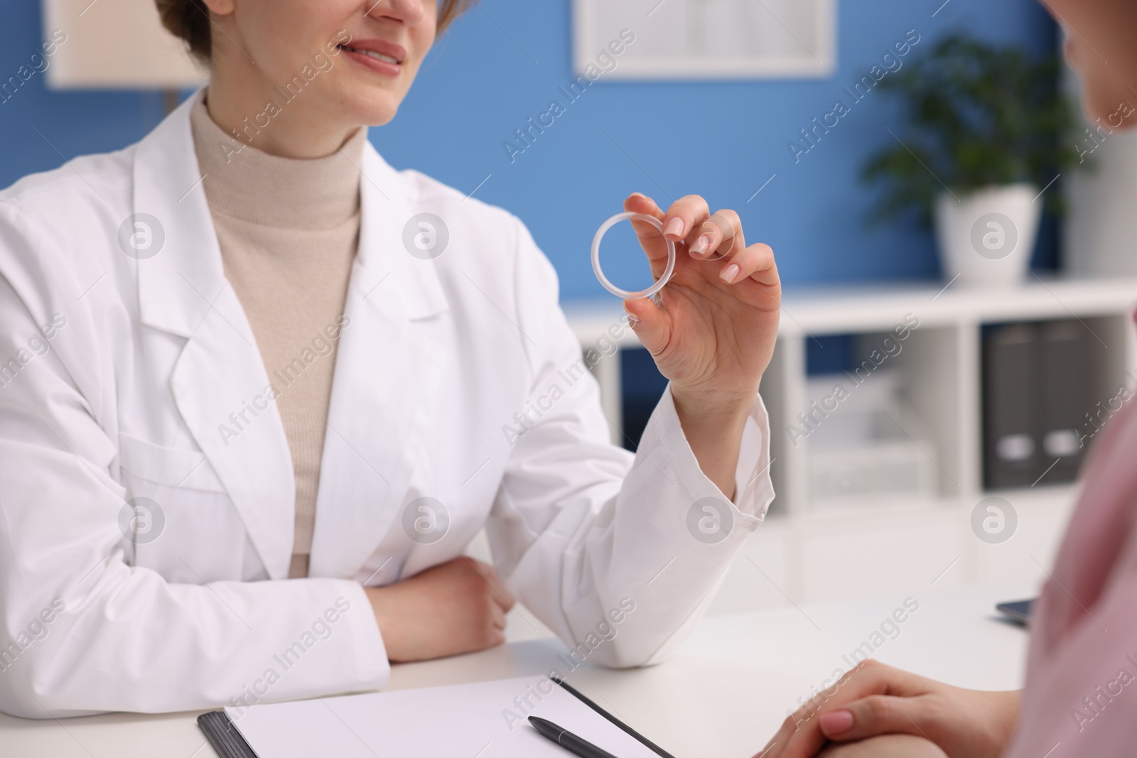 Photo of Contraception. Gynecologist recommending vaginal ring to woman in clinic, closeup