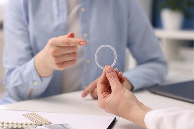 Photo of Contraception. Gynecologist recommending vaginal ring to woman in clinic, closeup