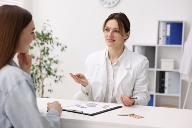 Photo of Contraception. Woman having appointment with gynecologist in clinic