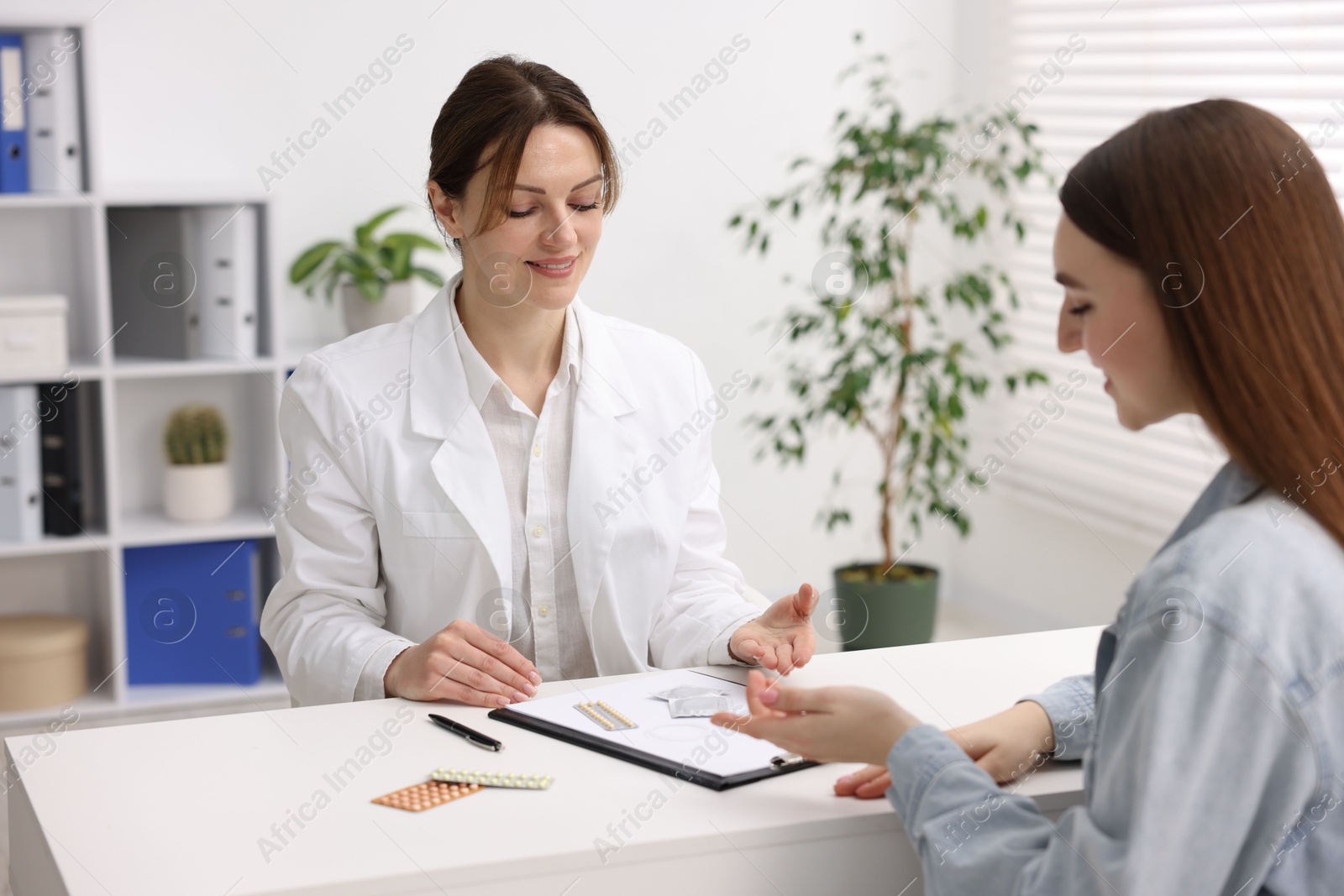 Photo of Contraception. Woman having appointment with gynecologist in clinic