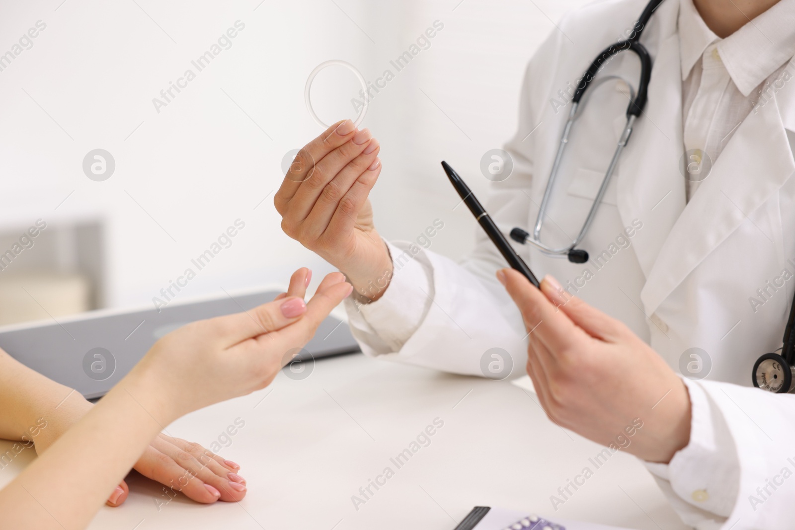 Photo of Contraception. Gynecologist recommending vaginal ring to woman in clinic, closeup