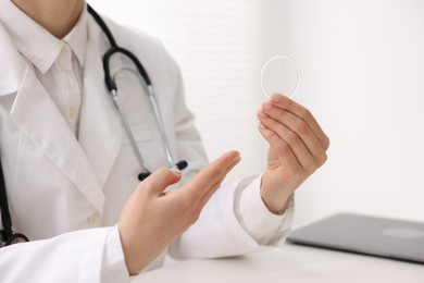 Contraception. Gynecologist showing vaginal ring in clinic, closeup