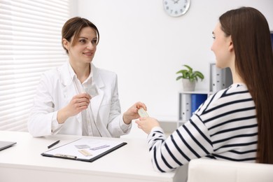 Contraception. Woman having appointment with gynecologist in clinic