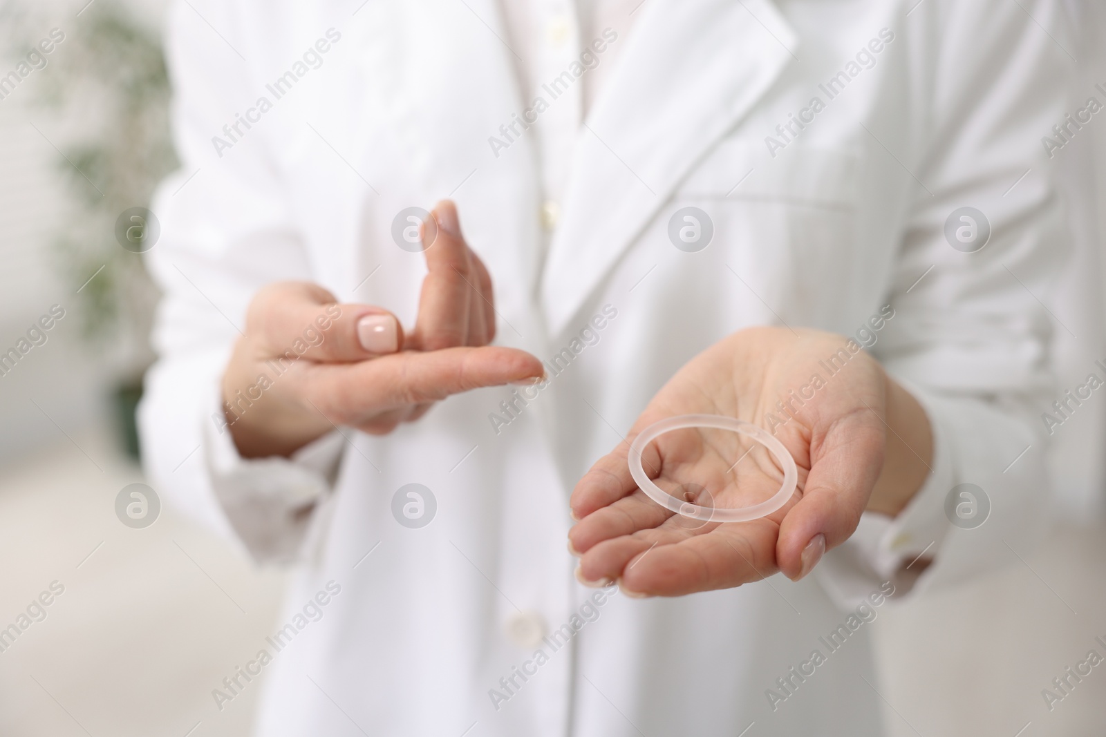 Photo of Contraception. Gynecologist showing vaginal ring in clinic, closeup