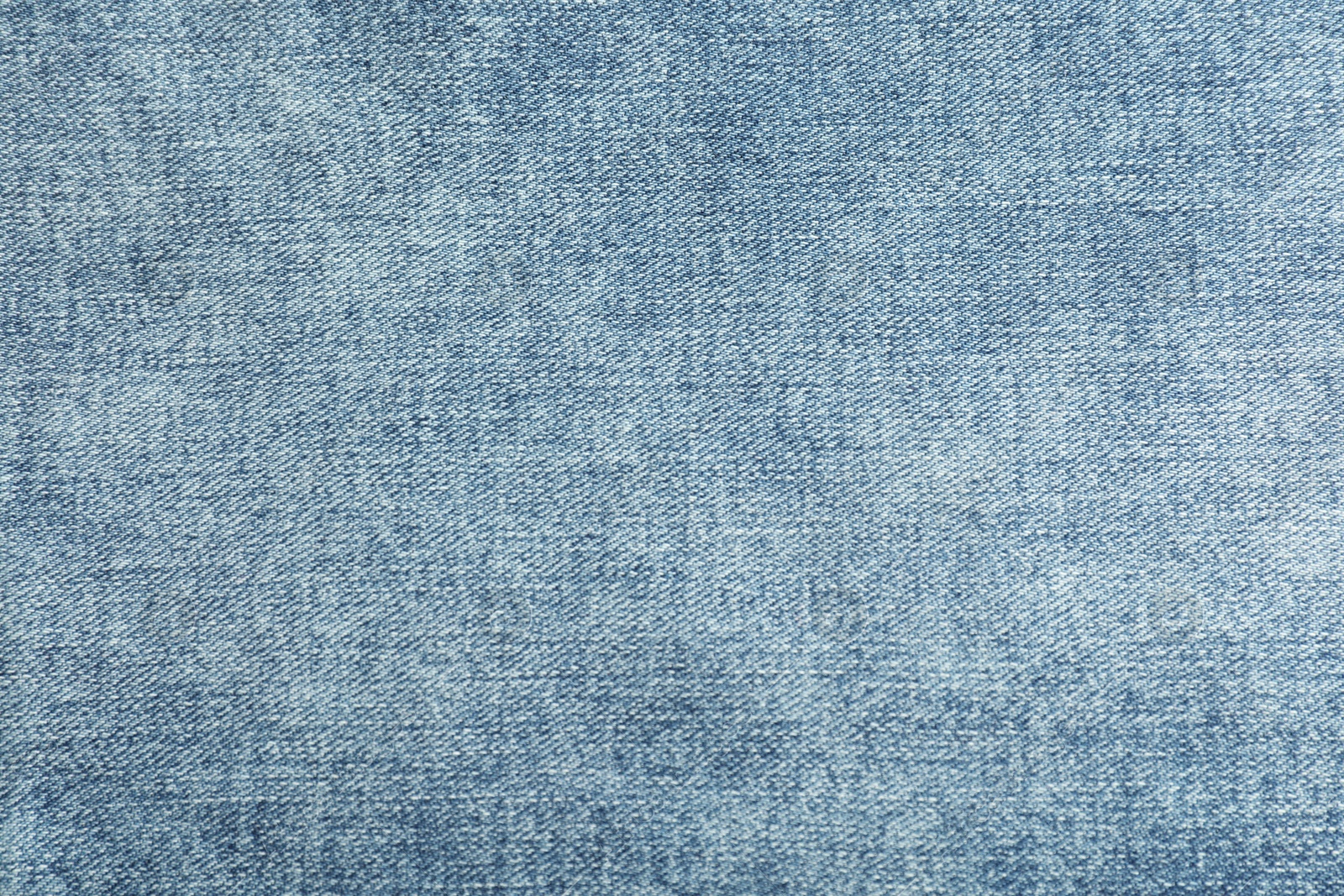 Photo of Texture of blue jeans as background, closeup