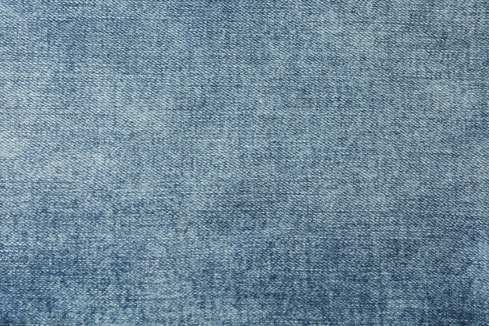 Photo of Texture of blue jeans as background, closeup