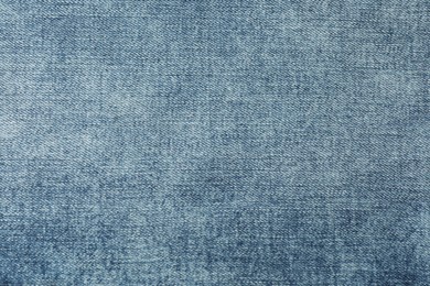 Photo of Texture of blue jeans as background, closeup