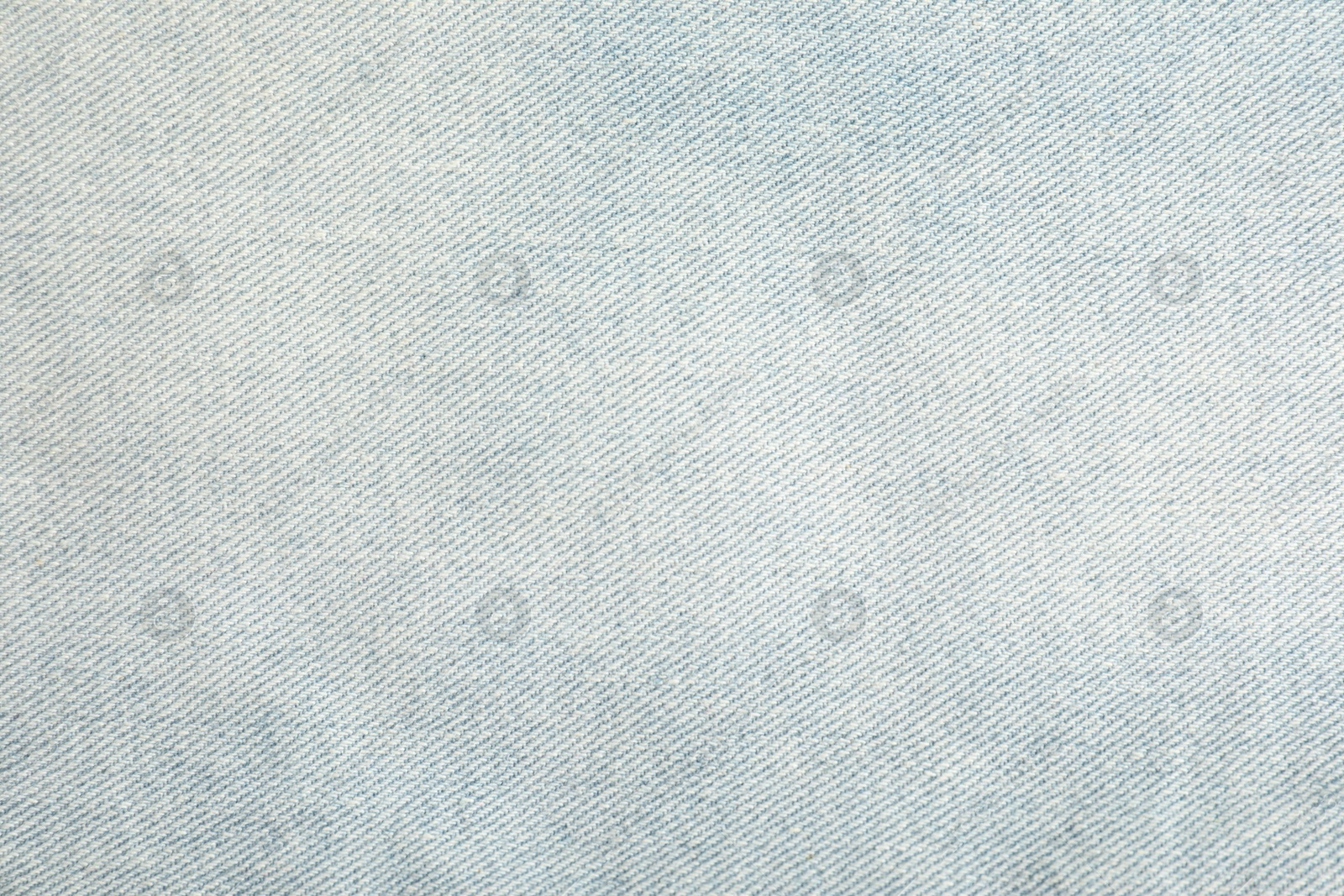 Photo of Texture of light blue jeans as background, closeup