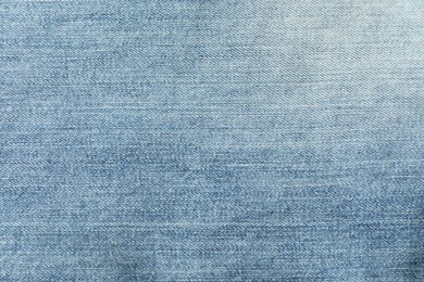 Photo of Texture of blue jeans as background, closeup