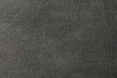 Photo of Texture of black jeans as background, closeup