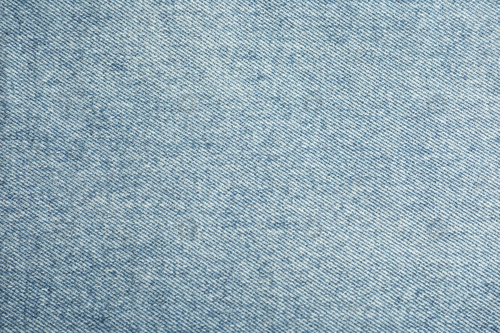 Photo of Texture of blue jeans as background, closeup