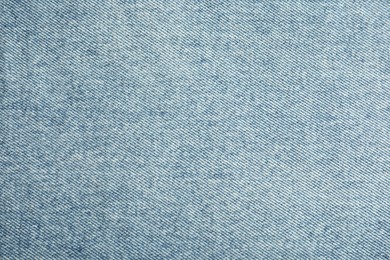 Photo of Texture of blue jeans as background, closeup