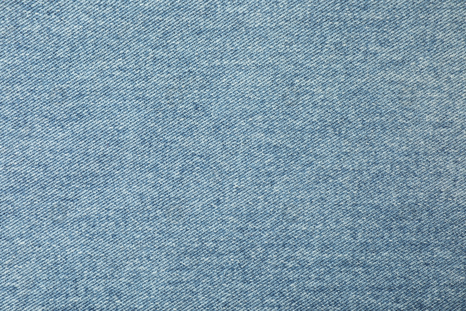 Photo of Texture of blue jeans as background, closeup