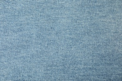 Photo of Texture of blue jeans as background, closeup