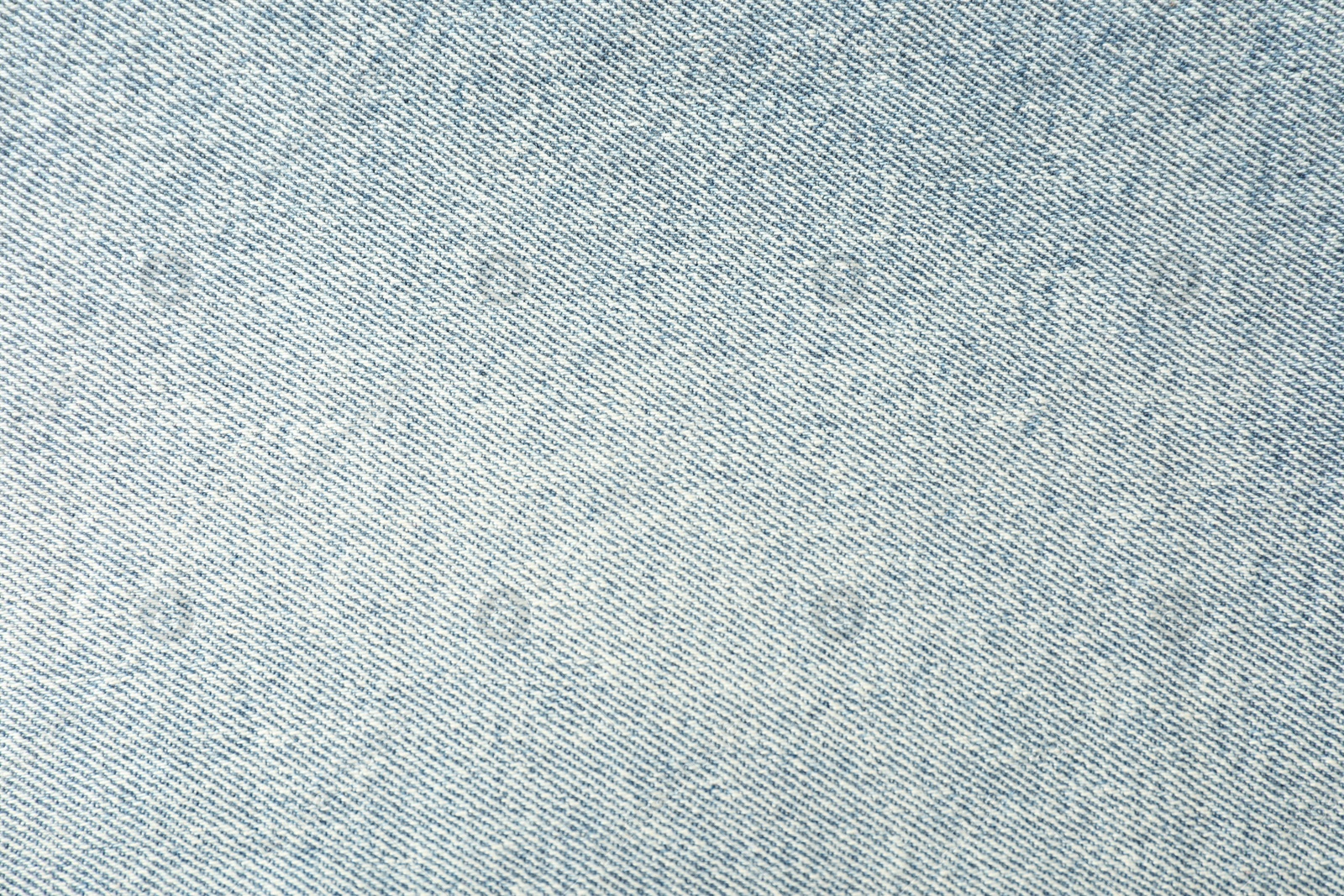 Photo of Texture of light blue jeans as background, closeup