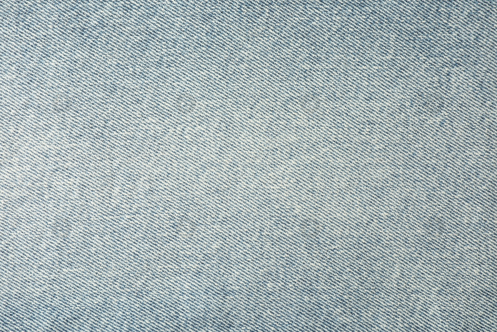 Photo of Texture of light blue jeans as background, closeup