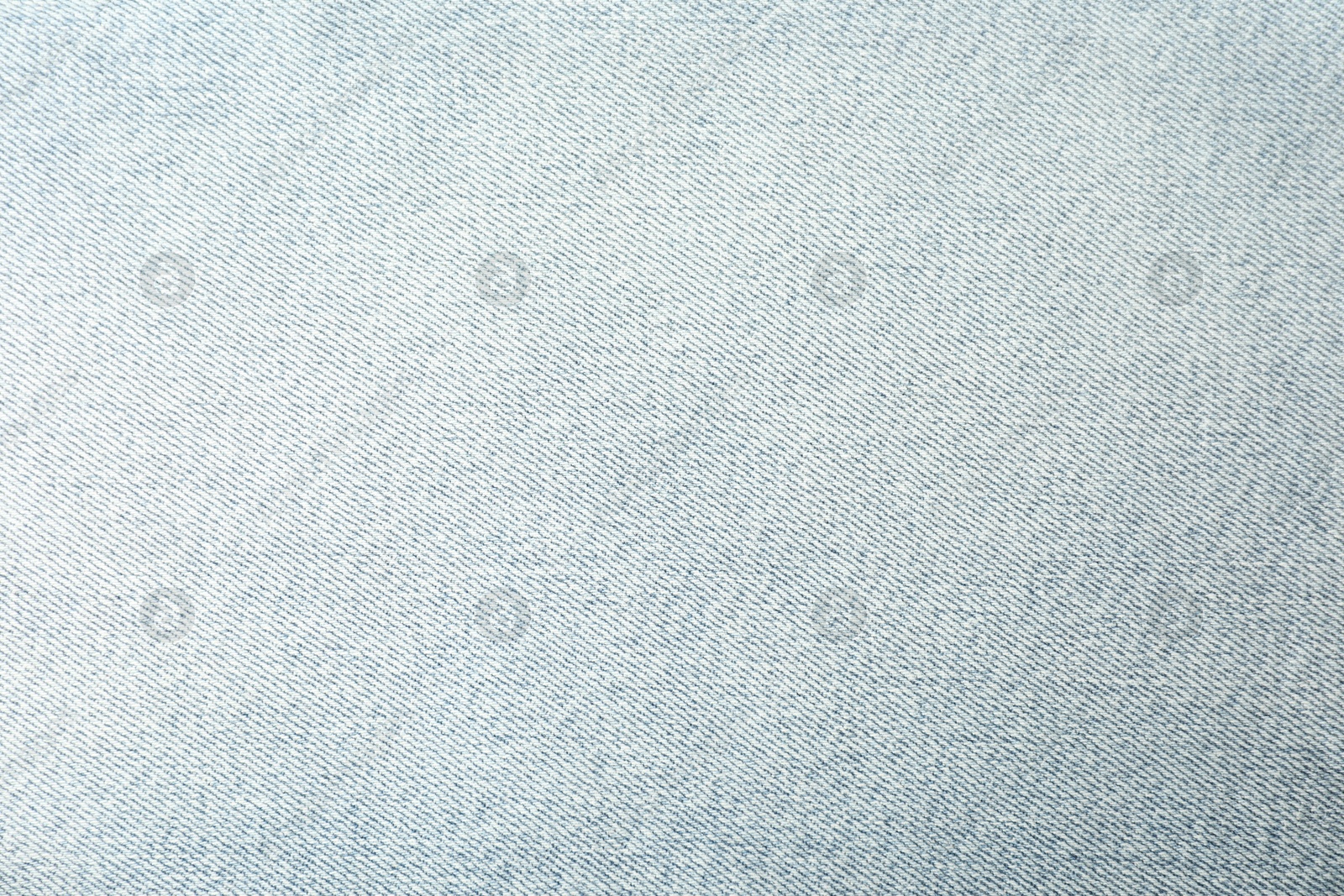 Photo of Texture of light blue jeans as background, closeup