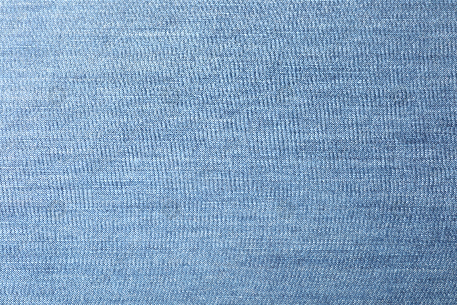 Photo of Texture of blue jeans as background, closeup