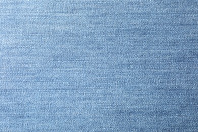 Photo of Texture of blue jeans as background, closeup