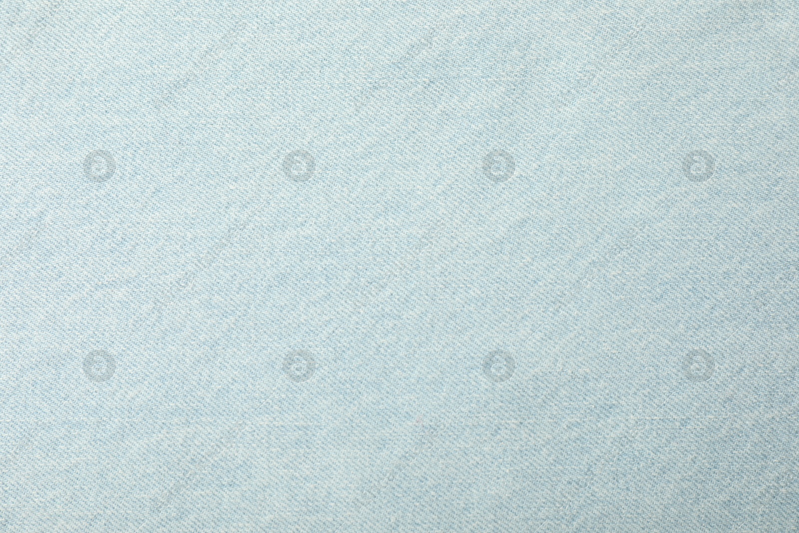 Photo of Texture of light blue jeans as background, closeup