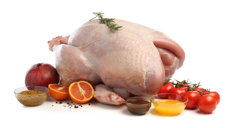 Photo of Whole raw turkey with ingredients isolated on white