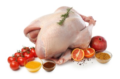 Photo of Whole raw turkey with ingredients isolated on white