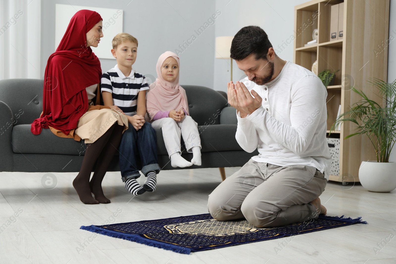 Photo of Happy Muslim family spending time together and praying at home