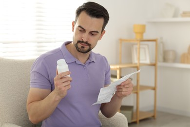 Man with pills and medical instruction at home