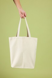 Woman with blank shopper bag on color background, closeup. Mockup for design