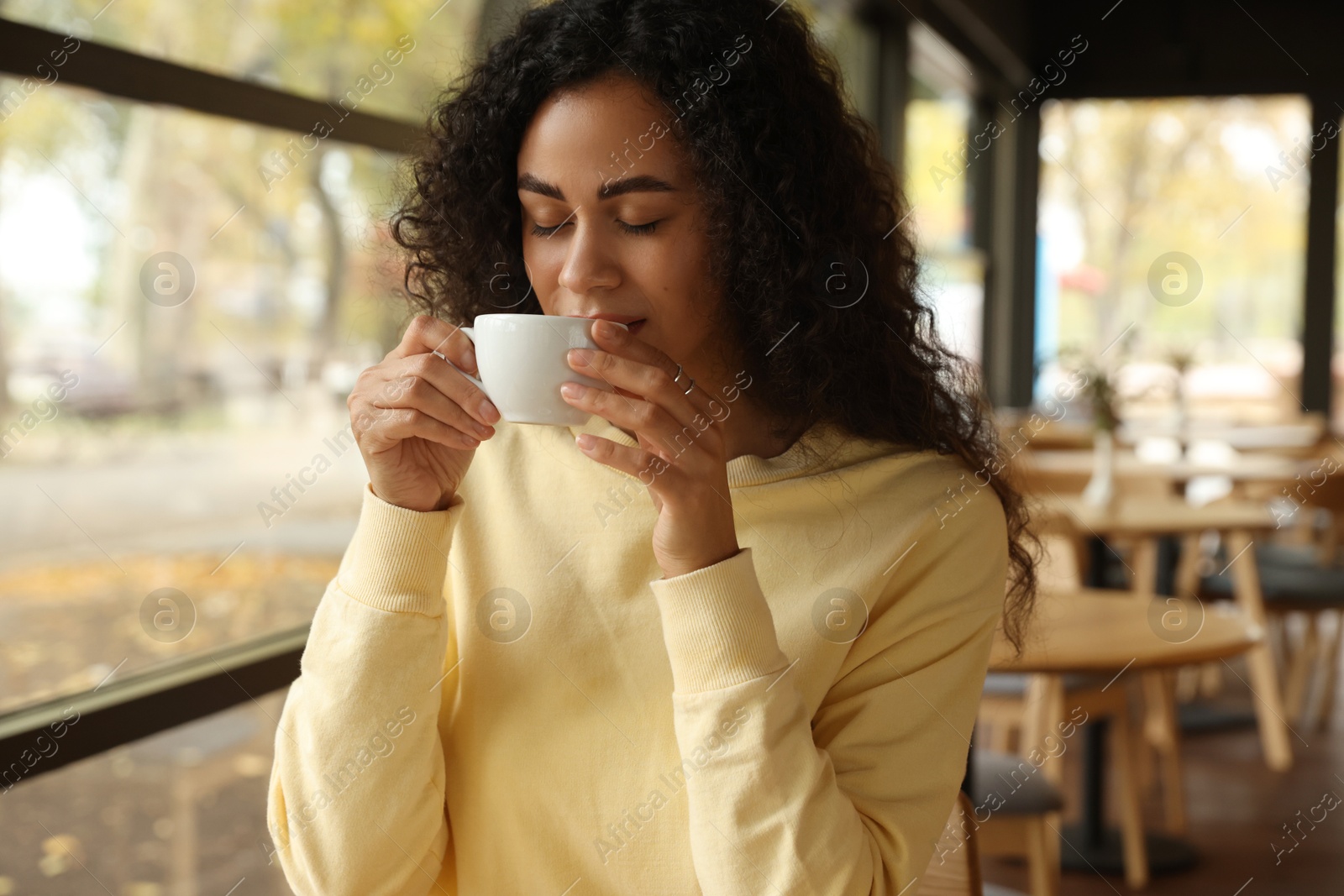 Photo of Woman enjoying her aromatic coffee in cafe