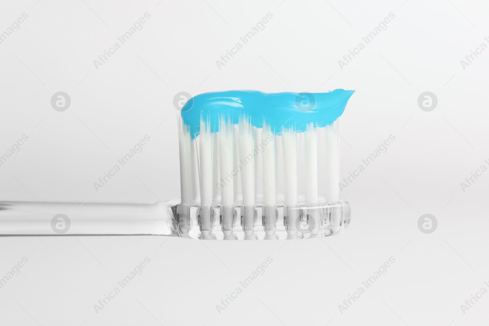 One toothbrush with toothpaste in air on white background, closeup Photo of One toothbrush with toothpaste in air on white background, closeup