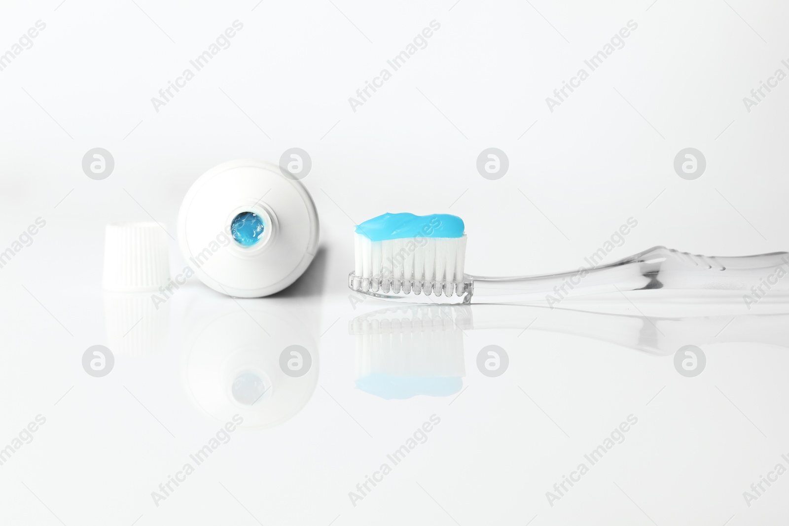 Toothbrush with toothpaste and tube on white background Photo of Toothbrush with toothpaste and tube on white background