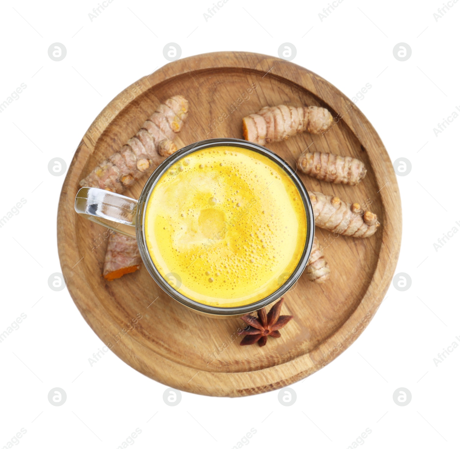 Photo of Delicious turmeric latte in glass cup, roots and anise star isolated on white, top view