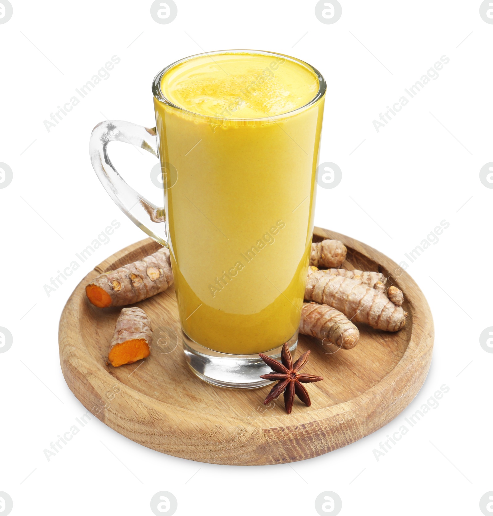 Photo of Delicious turmeric latte in glass cup, roots and anise star isolated on white