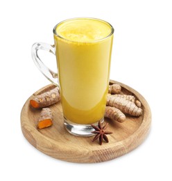 Photo of Delicious turmeric latte in glass cup, roots and anise star isolated on white